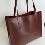 Brown leather university tote bag for students.