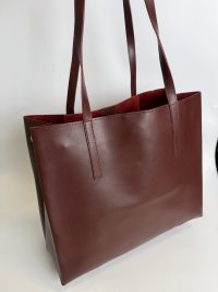 Brown leather university tote bag for students.