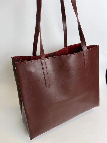 Brown leather university tote bag for students.