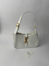 White YSL Hobo bag with gold logo and strap buckle.