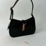Elegant black YSL Hobo bag with gold logo and strap.