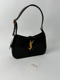 Elegant black YSL Hobo bag with gold logo and strap.