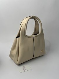 Elegant Coach Tote Bag with logo, beige leather design.