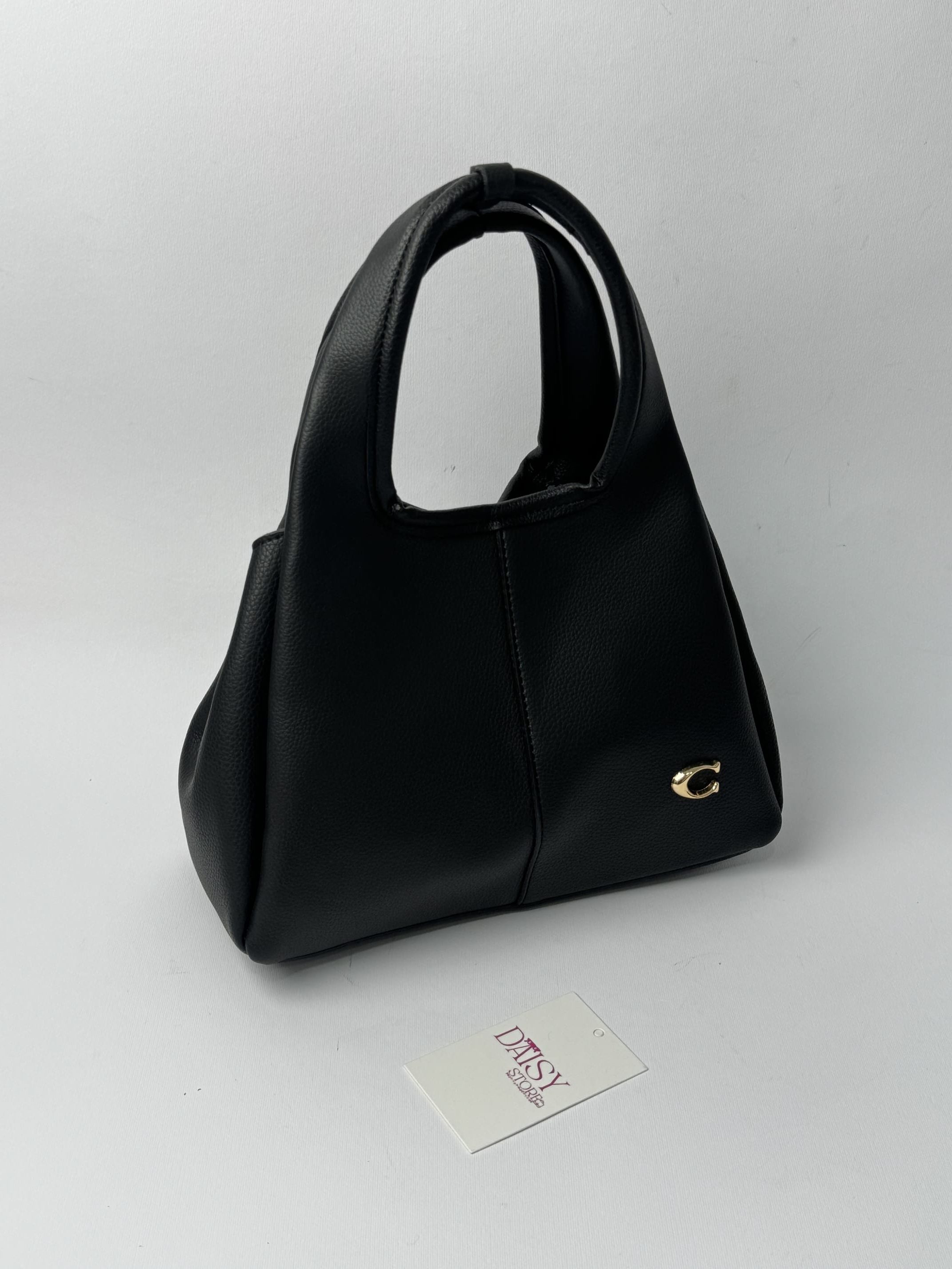 ds-canta-180-kryesore Black Coach Tote Bag with gold C logo on display.