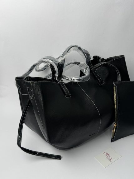 Polene black tote bag with small pouch on display.