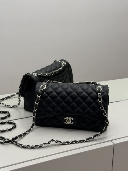 Black Chanel Classic Flap bag with quilted leather and chain strap.