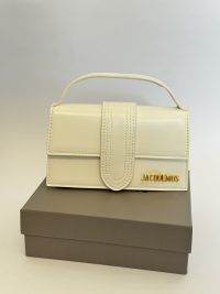 Elegant white Jacquemus Le Bambino mini bag on box.