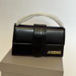 Black Jacquemus Le Bambino mini bag on display box.