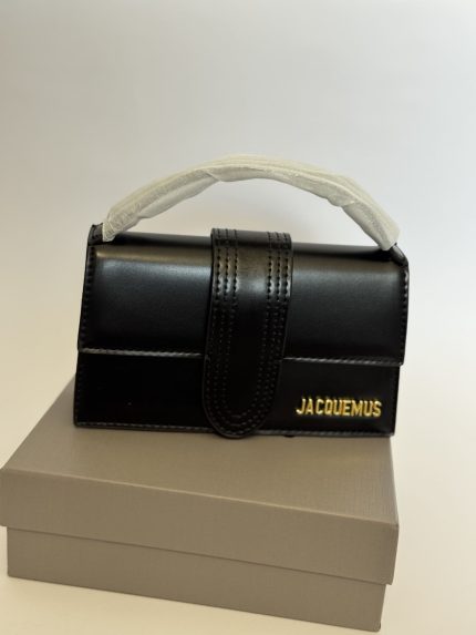 Black Jacquemus Le Bambino mini bag on display box.