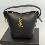 Elegant YSL black bucket bag with gold logo detail on box.