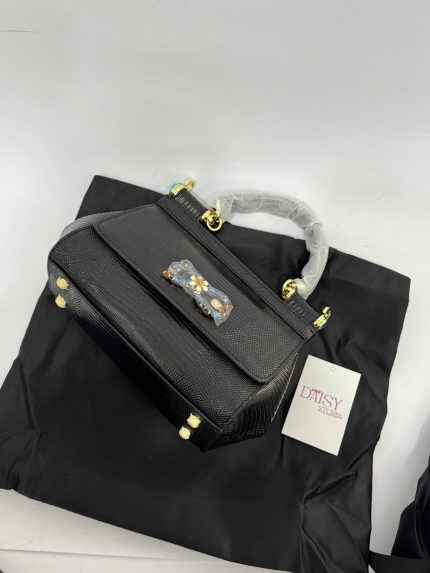 Black Dolce Gabbana Sicily handbag with gold accents on black fabric.