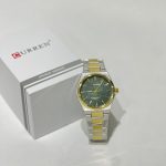 Curren Ora Rrumbullake Dial Jeshile watch with green dial and gold accents.