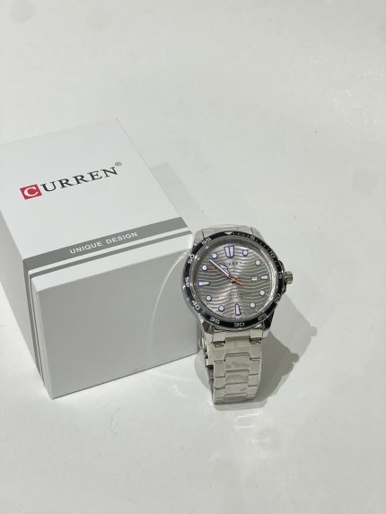Curren Ora Diver watch with silver bracelet and box on white background.