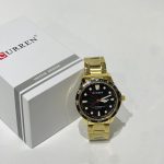 Curren Ora Diver Dial Men's Watch, gold bracelet, black face.