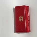 Red Chanel women's wallet with gold logo, elegant and stylish design.