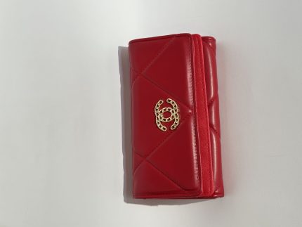 Red Chanel women's wallet with gold logo, elegant and stylish design.