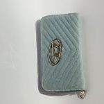 Elegant blue Diesel women's wallet with chevron pattern and logo.