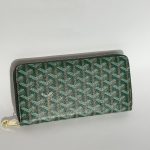 Green Goyard women's wallet with elegant pattern and gold zipper.