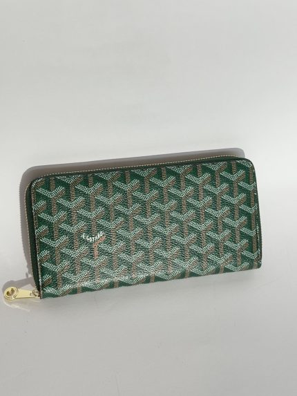 Green Goyard women's wallet with elegant pattern and gold zipper.