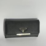 Elegant black women's wallet with logo detail.