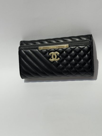 Black Chanel women's wallet with quilted design and logo.