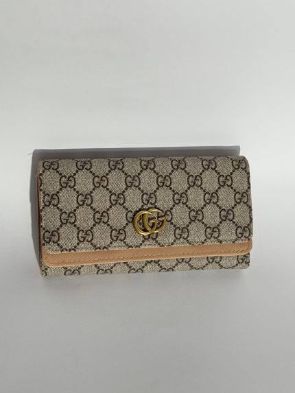 Stylish women's Diesel wallet with patterned design and gold logo.