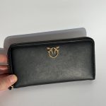 Miu Miu black leather women's wallet with gold logo.