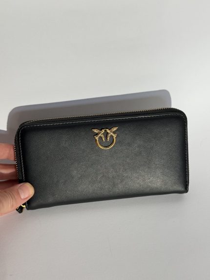 Miu Miu black leather women's wallet with gold logo.