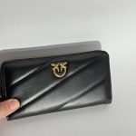 Elegant black Guess women's wallet with gold logo detail.