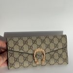 Elegant women's wallet with gold clasp and patterned design.