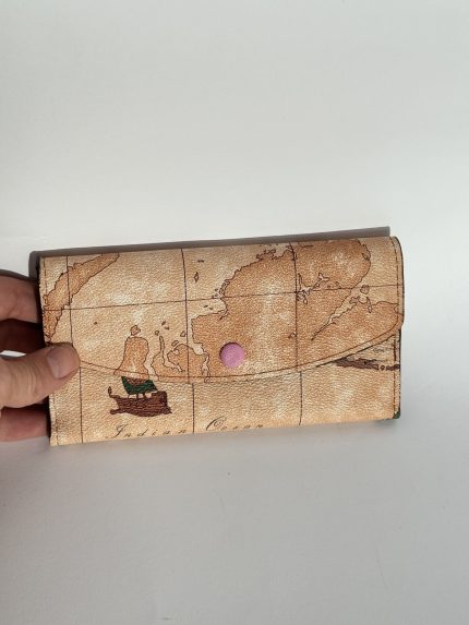 Elegant Goyard women's wallet with world map design.
