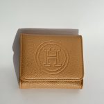 Tan leather wallet with embossed logo, elegant and stylish design.