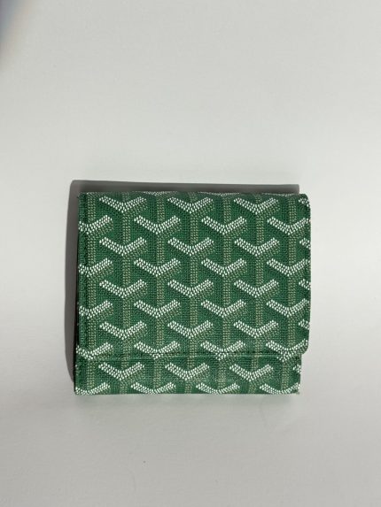 Green patterned Chanel women's wallet on white background.
