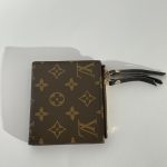 Elegant Louis Vuitton women's wallet with iconic monogram design.