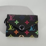Colorful patterned women's wallet on light background.