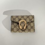 Elegant Goyard women's wallet with patterned design and gold clasp.