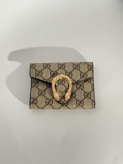 Elegant Goyard women's wallet with patterned design and gold clasp.
