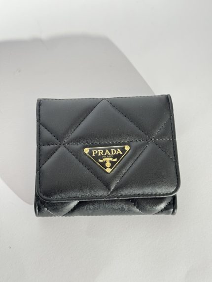 Black quilted leather wallet with gold logo emblem.