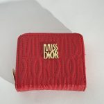 Red embossed wallet with gold logo detailing.