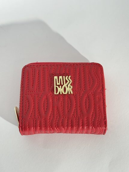 Red embossed wallet with gold logo detailing.