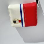 Red, white, blue wallet with gold logo, elegant design.