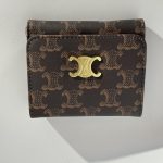 Elegant women's wallet with gold accents and stylish pattern.