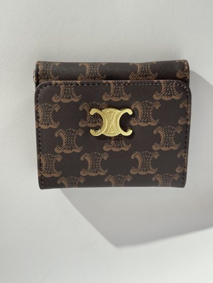 Elegant women's wallet with gold accents and stylish pattern.