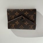 Elegant brown patterned women's wallet with button closure.