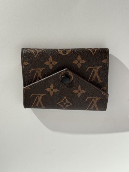 Elegant brown patterned women's wallet with button closure.
