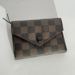 Elegant Goyard women's wallet with checkered pattern, stylish design.