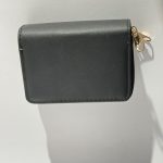 Elegant women's wallet with gold zipper on white background.