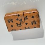 Elegant women's wallet with logo pattern and zip closure.