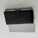 Elegant black women's wallet with zipper and clasp.