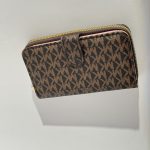 Michael Kors women's wallet, brown patterned design, zip closure.